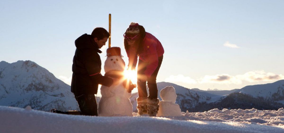 Ein Paar baut einen Schneemann