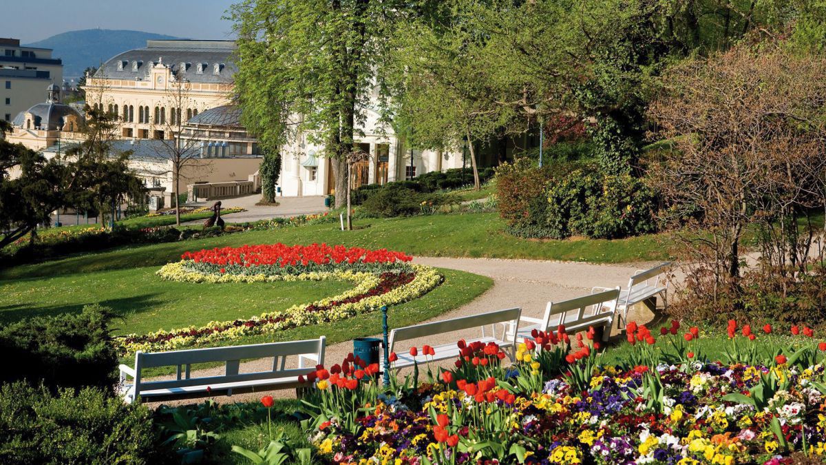 Kurpark mit Blumenarrangements.