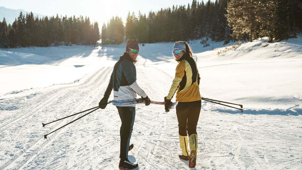 Paar auf dem Weg zur Langlaufloipe