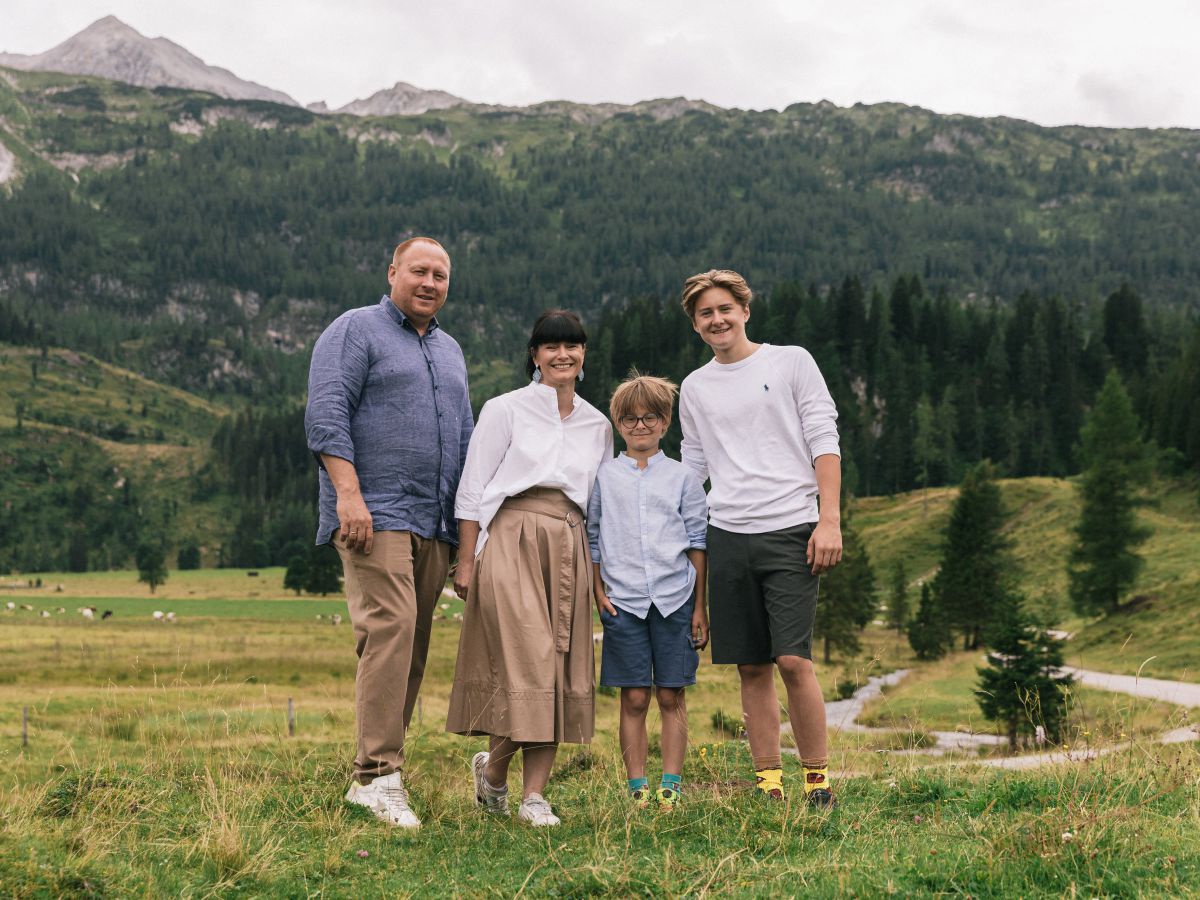 Die vier stehen auf einer Almwiese.